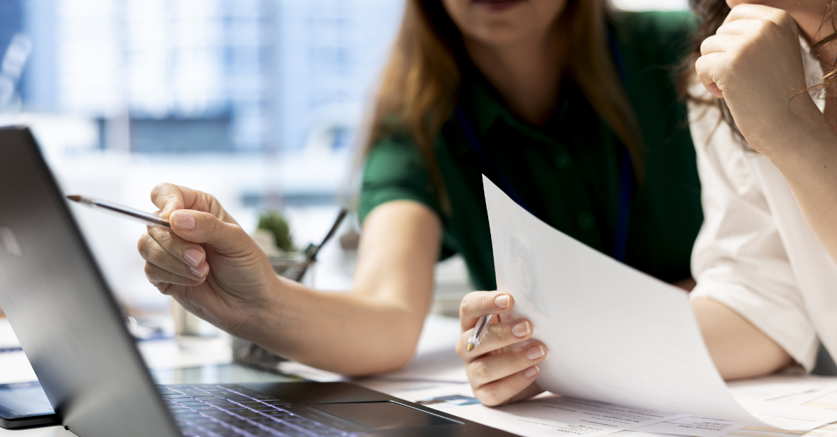 coworkers-using-laptop-to-check-on-work-permit